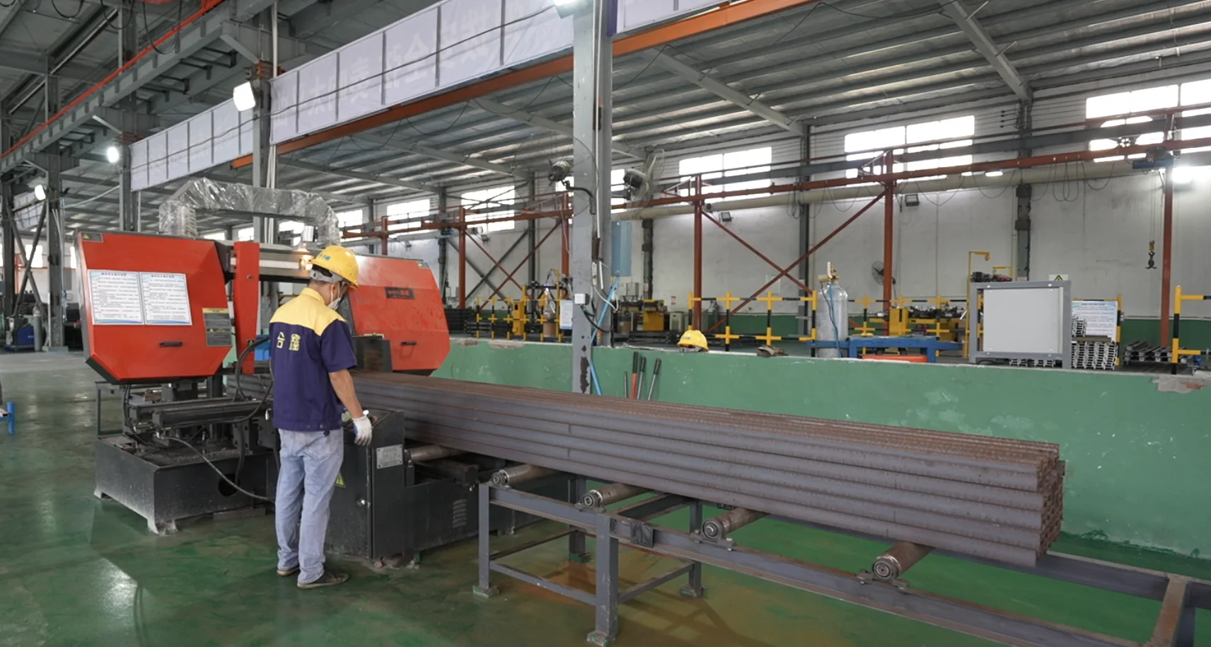 Band saw cutting of steel sections at the Hexin workshop