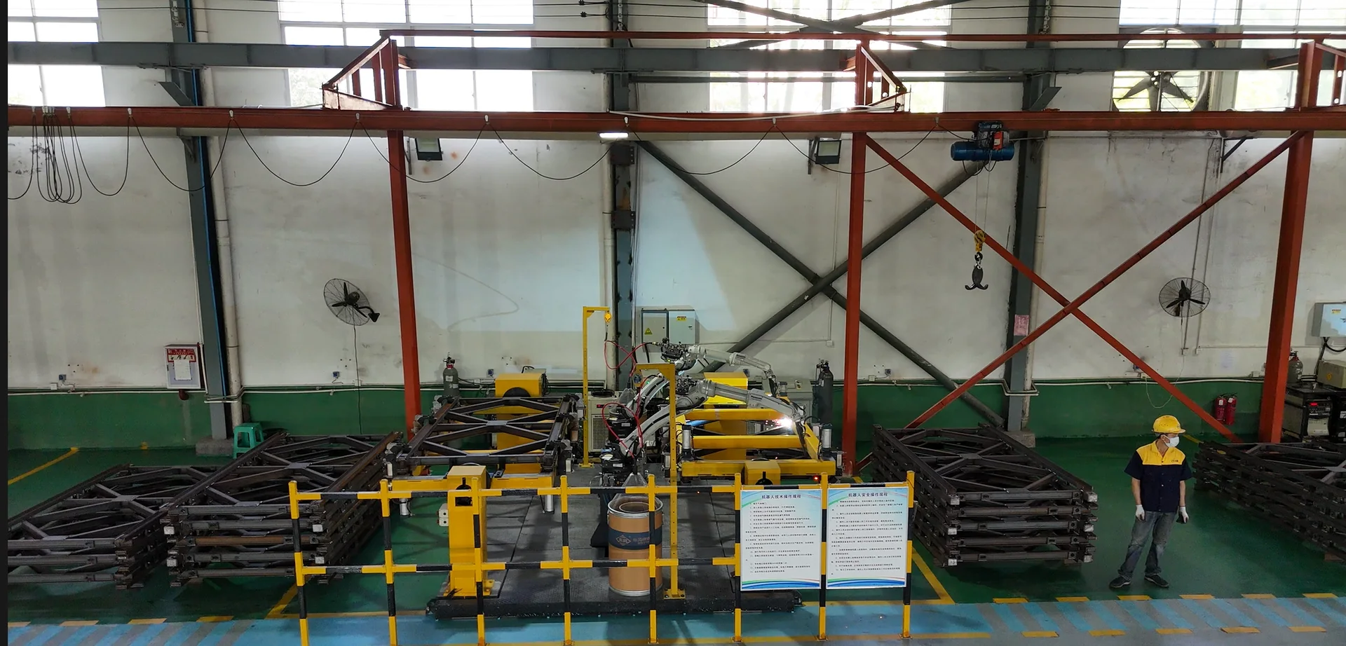 Robotic welding cells and positioning fixtures in the Hexin workshop