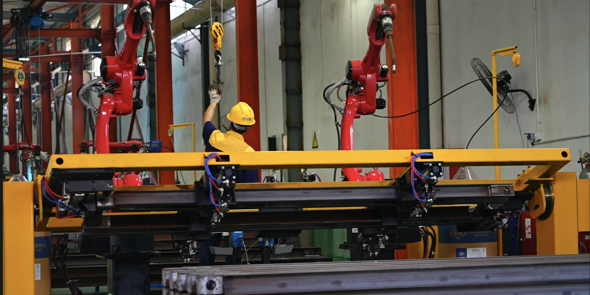 Operator supervising the robotic welding process